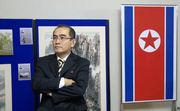In a video grab created on August 17, 2016 taken from footage recorded by AFPTV on November 3, 2014 deputy ambassador at the North Korean embassy in London, Thae Yong-ho, stands in front of an artwork during a photocall to view an exhibition of North Korean art at the North Korean embassy in west London - Sputnik International