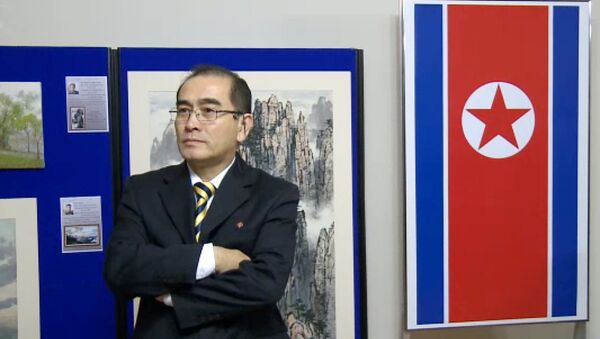 In a video grab created on August 17, 2016 taken from footage recorded by AFPTV on November 3, 2014 deputy ambassador at the North Korean embassy in London, Thae Yong-ho, stands in front of an artwork during a photocall to view an exhibition of North Korean art at the North Korean embassy in west London - Sputnik International