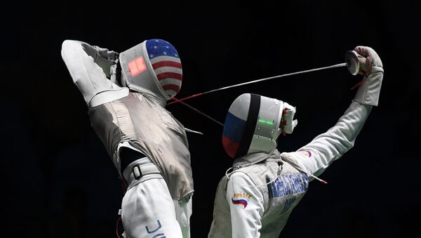 US Gerek Meinhardt (L) competes against Russia's Artur Akhmatkhuzin during the men’s team foil semi-final bout between Russia and US as part of the fencing event of the Rio 2016 Olympic Games, on August 12, 2016, at the Carioca Arena 3, in Rio de Janeiro - Sputnik International