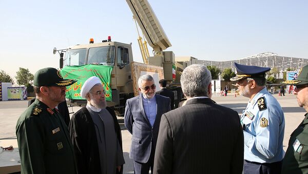 Iran's President Hassan Rouhani (2nd L) and Defence Minister Hossein Dehghan (L) stand near the new air defense missile system Bavar-373, in Tehran, Iran August 21, 2016 - Sputnik International