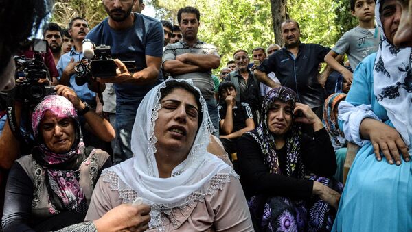 Women cry during a funeral for a victim of last night's attack on a wedding party that left 50 dead in Gaziantep in southeastern Turkey near the Syrian border on August 21, 2016 - Sputnik International