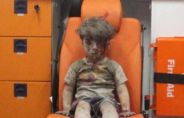 Five-year-old Omran Daqneesh, with bloodied face, sits inside an ambulance after he was rescued following an airstrike in the rebel-held al-Qaterji neighbourhood of Aleppo, Syria August 17, 2016. Five-year-old Omran Daqneesh, with bloodied face, sits inside an ambulance after he was rescued following an airstrike in the rebel-held al-Qaterji neighbourhood of Aleppo, Syria August 17, 2016. - Sputnik International