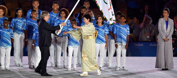 International Olympic Committee (IOC) President Thomas Bach (L) gives the Olympic flag to Tokyo's governor Yuriko Koike during the closing ceremony of the Rio 2016 Olympic Games at the Maracana stadium in Rio de Janeiro on August 21, 2016. International Olympic Committee (IOC) President Thomas Bach (L) gives the Olympic flag to Tokyo's governor Yuriko Koike during the closing ceremony of the Rio 2016 Olympic Games at the Maracana stadium in Rio de Janeiro on August 21, 2016. - Sputnik International