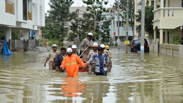 Members of the fire forces and volunteers participate in relief operations in a low lying flooded area of Bangalore (File) - Sputnik International