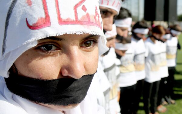 Yazidi women attend a demonstration at a refugee camp in Kurdish-dominated city of Diyarbakir, Turkey, to mark the second anniversary of what a U.N.-appointed commission of independent war crimes investigators termed a genocide against the Yazidi population by the Islamic State, August 3, 2016 - Sputnik International
