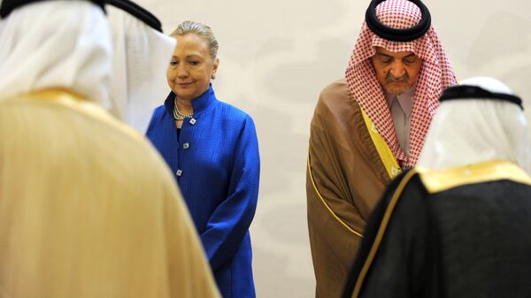 Saudi Foreign Minister Prince Saud Al-Faisal (R) escorts US Secretary of State Hillary Clinton as they arrive for a group picture with other Gulf counetrparts during their meeting in the Saudi capital of Riyadh, on March 31, 2012 - Sputnik International