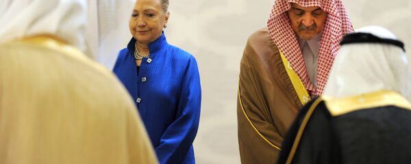 Saudi Foreign Minister Prince Saud Al-Faisal (R) escorts US Secretary of State Hillary Clinton as they arrive for a group picture with other Gulf counetrparts during their meeting in the Saudi capital of Riyadh, on March 31, 2012 Saudi Foreign Minister Prince Saud Al-Faisal (R) escorts US Secretary of State Hillary Clinton as they arrive for a group picture with other Gulf counetrparts during their meeting in the Saudi capital of Riyadh, on March 31, 2012 - Sputnik International