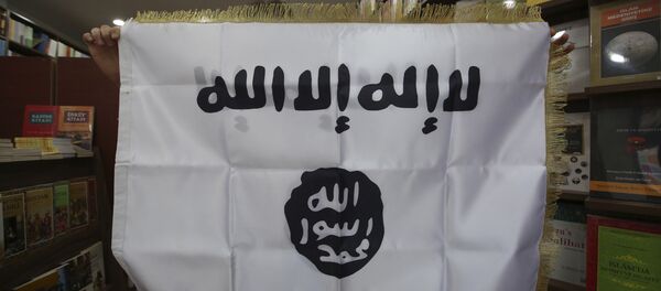 Oct. 13, 2014 photo, a man shows an IS flag at an Islamic bookstore in the Fatih district of Istanbul - Sputnik International