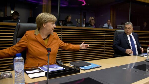German Chancellor Angela Merkel, left, gestures regarding the space between chairs as she speaks with Hungarian Prime Minister Viktor Orban prior to the start of a round table meeting during an EU summit at EU headquarters in Brussels on Sunday, Oct. 25, 2015. - Sputnik International