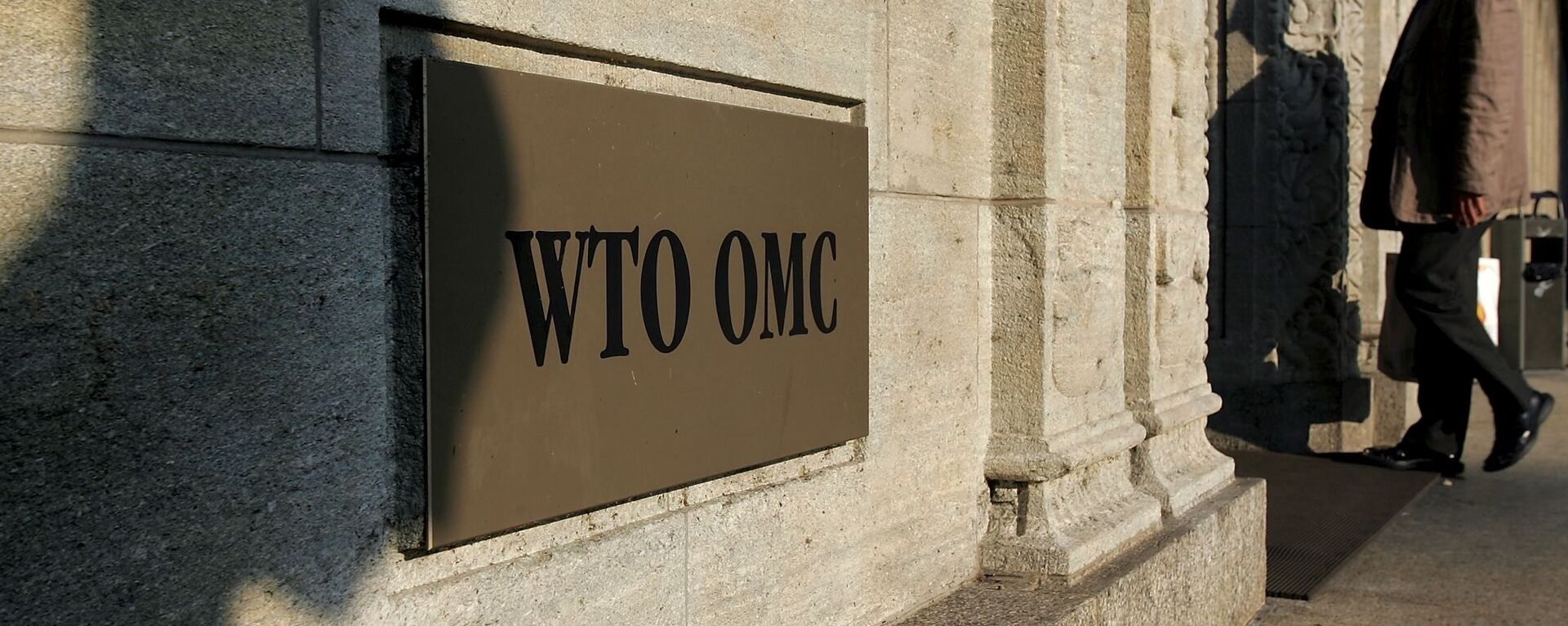 The shadow of a sculpture is reflected on the World Trade Organisation, WTO sign near the entrance of the headquarters, in Geneva (File) - Sputnik International, 1920, 30.09.2020