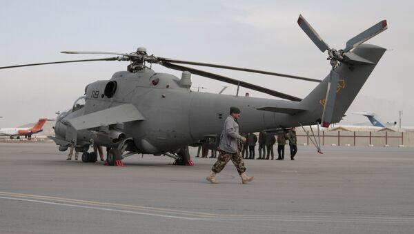 An Afghan soldier walks past Indian donated helicopters to Afghanistan at the Kabul airport in Kabul, Afghanistan, Friday, Dec. 25, 2015 - Sputnik International