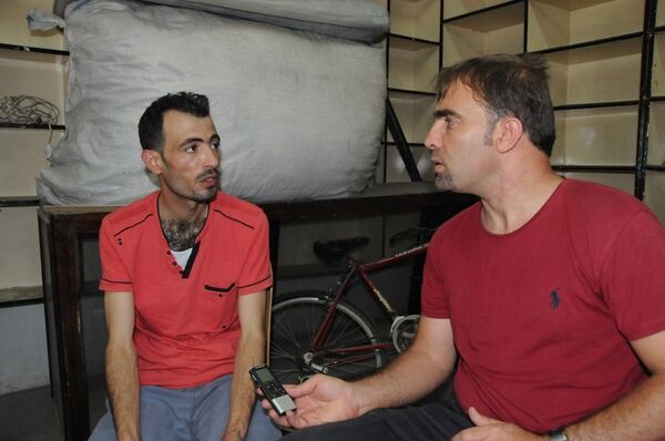 Hasan Cuma (left), another Syrian refugee, speaking to Sputnik reporter. His son Usama was killed in Saturday's attack; his other son, Hussein, is in intensive care. Hasan Cuma (left), another Syrian refugee, speaking to Sputnik reporter. His son Usama was killed in Saturday's attack; his other son, Hussein, is in intensive care. - Sputnik International