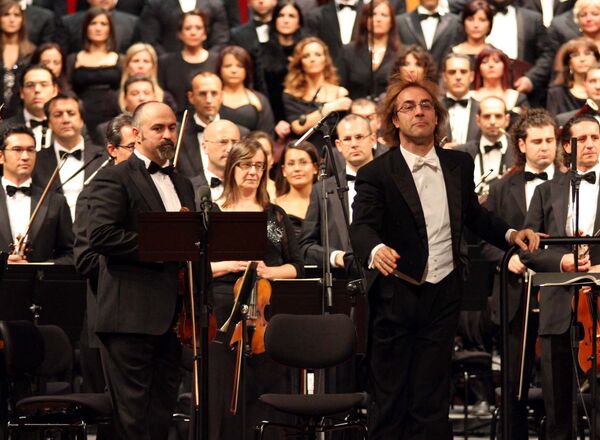 A view of the Bari province symphonic orchestra directed by Fabio Mastrangelo, at right in foreground, during a concert to mark the reopening of the Petruzzelli theatre, in Bari southern Italy. (File) A view of the Bari province symphonic orchestra directed by Fabio Mastrangelo, at right in foreground, during a concert to mark the reopening of the Petruzzelli theatre, in Bari southern Italy. (File) - Sputnik International