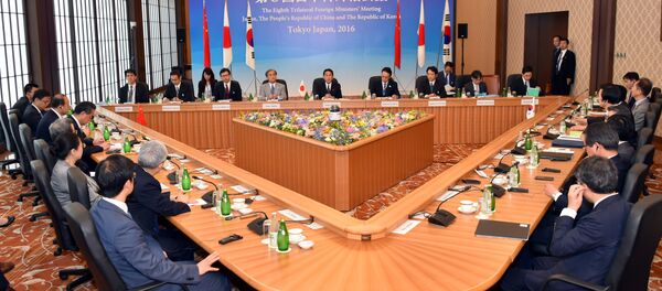 Japanese Foreign Minister Fumio Kishida, center in the background, makes opening remark during a trilateral meeting in Tokyo, Wednesday, Aug. 24, 2016 - Sputnik International