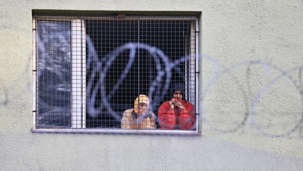 Migrants watch out of a window behind a fence at the Bela-Jezova detention centre for refugees near Bela pod Bezdezem, northeast of Prague (File) - Sputnik International