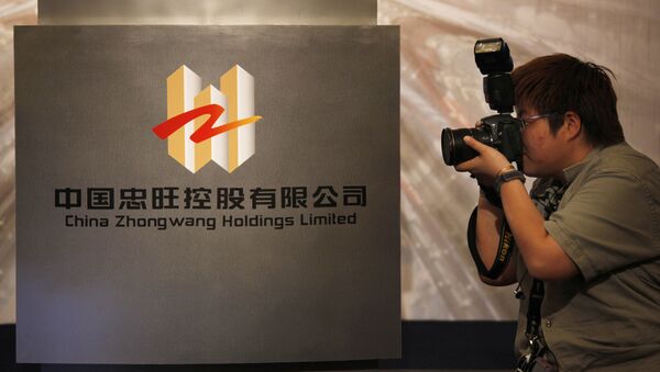 A photographer takes a picture of the logo of China Zhongwang Holdings Limited displayed at a news conference in Hong Kong (File) - Sputnik International