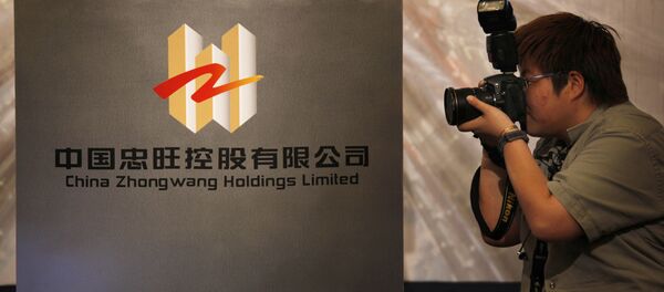 A photographer takes a picture of the logo of China Zhongwang Holdings Limited displayed at a news conference in Hong Kong (File) - Sputnik International