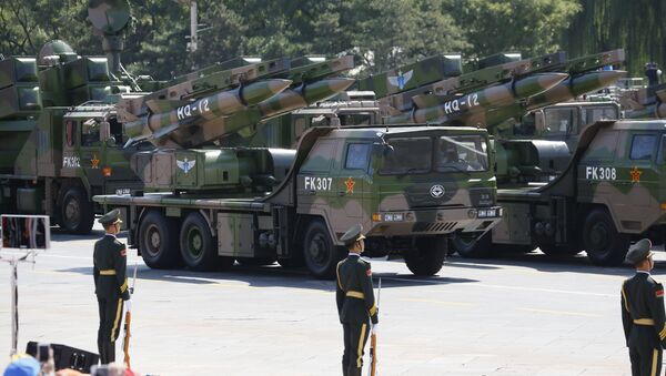 Military vehicles carry HQ-12 surface-to-air missile batteries during a parade commemorating the 70th anniversary of Japan's surrender during World War II. - Sputnik International