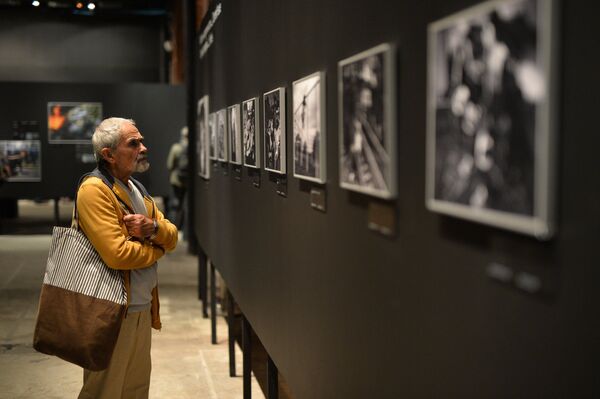 A visitor at the opening of a photo exhibition of the prizewinners in the Andrei Stenin International Press Photo Contest in Moscow. File photo - Sputnik International