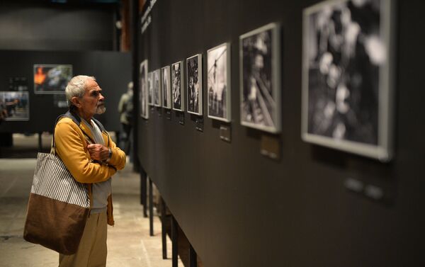 A visitor at the opening of a photo exhibition of the prizewinners in the Andrei Stenin International Press Photo Contest in Moscow. File photo - Sputnik International