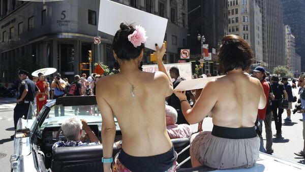 Participants ride in a convertible through midtown Manhattan in the Go Topless Pride Parade, Sunday, Aug. 28, 2016, in New York - Sputnik International