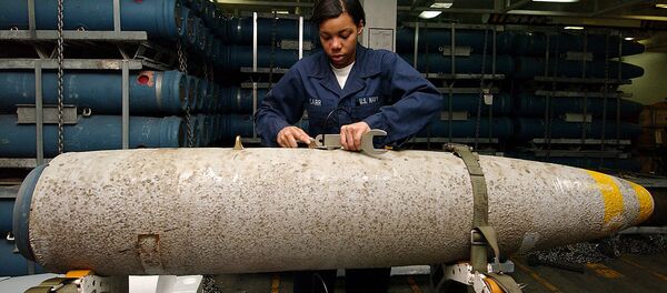 An aviation ordnance technician handling the bomb body of a thermally protected (insulated to slow cook-off time in case of fire) Mark 84 aboard the USS George Washington. An aviation ordnance technician handling the bomb body of a thermally protected (insulated to slow cook-off time in case of fire) Mark 84 aboard the USS George Washington. - Sputnik International