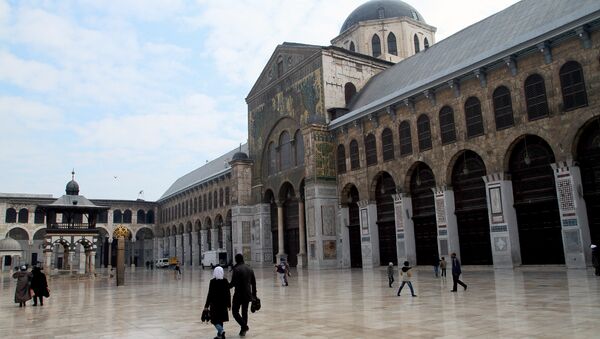 Syrian Muslims walk in the courtyard of the historic Umayyad Mosque before weekly prayers in Damascus, Syria. File photo - Sputnik International