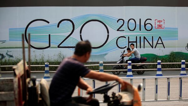 People cycle past a billboard for the upcoming G20 summit in Hangzhou, Zhejiang province, China, July 29, 2016 - Sputnik International