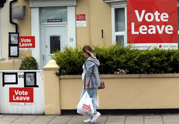 A woman walks past a house where Vote Leave boards are displayed in Redcar, north east England on June 27, 2016. A woman walks past a house where Vote Leave boards are displayed in Redcar, north east England on June 27, 2016. - Sputnik International