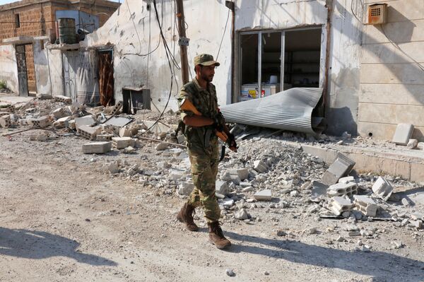 A member of Turkish-backed Free Syrian Army (FSA) patrols in the border town of Jarablus, Syria - Sputnik International