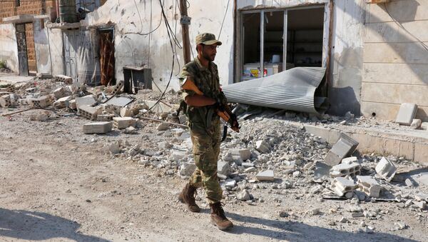 A member of Turkish-backed Free Syrian Army (FSA) patrols in the border town of Jarablus, Syria - Sputnik International