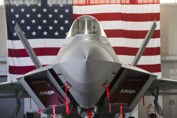 A US Air Force Lockheed Martin F-22 Raptor stealth fighter aircraft is parked inside a hangar A US Air Force Lockheed Martin F-22 Raptor stealth fighter aircraft is parked inside a hangar - Sputnik International