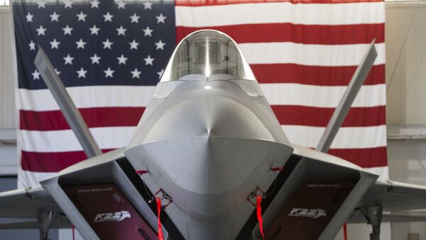 A US Air Force Lockheed Martin F-22 Raptor stealth fighter aircraft is parked inside a hangar - Sputnik International
