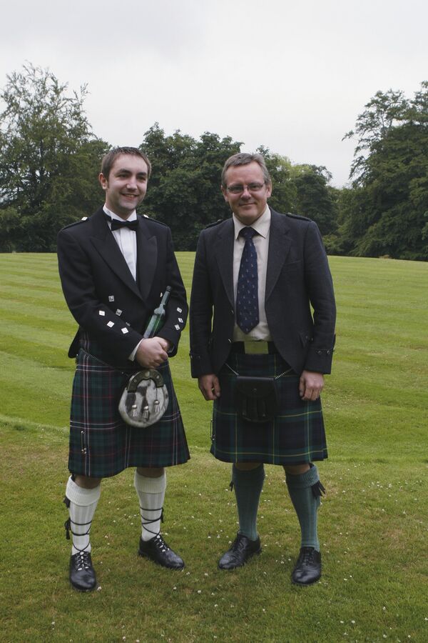 Scottish men in traditional dress with a bottle of whiskey near Dufftown. (File) - Sputnik International