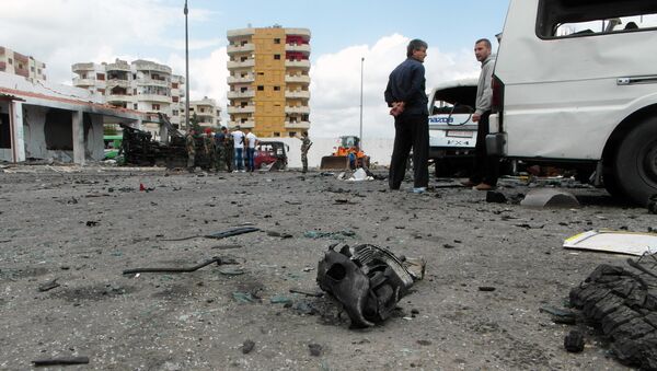 Syrians gather at the scene of multiple bombings in the the city of Tartus northwest of Damascus. File photo - Sputnik International