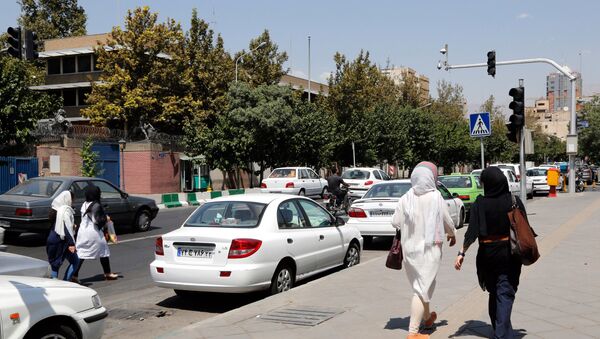 Iranians walk past the closed British embassy in the capital Tehran, on August 21, 2015 - Sputnik International