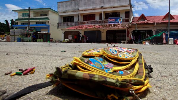 A school bag lies on a street next to the site of a bomb attack at Tak Bai district in the troubled southern province of Narathiwat, Thailand, September 6, 2016 - Sputnik International