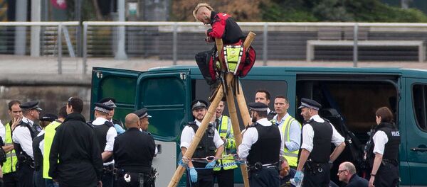 Emergency services surround protestors from the movement Black Lives Matter after they locked themselves to a tripod on the runway at London City Airport in London on September 6, 2016 Emergency services surround protestors from the movement Black Lives Matter after they locked themselves to a tripod on the runway at London City Airport in London on September 6, 2016 - Sputnik International