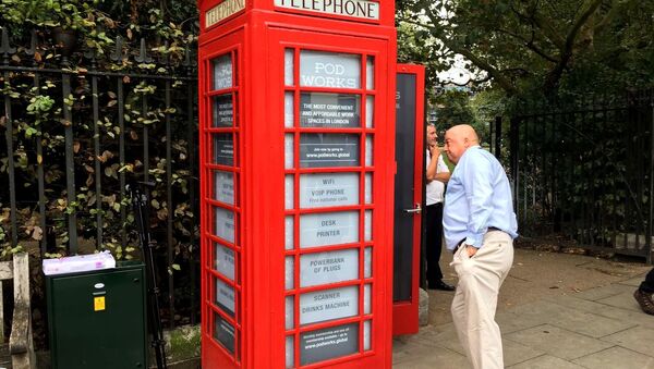 Britain's iconic red public telephone boxes turned into work pods. - Sputnik International