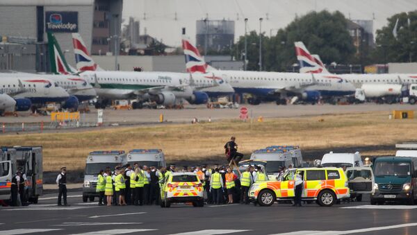 Emergency services surround protestors from the movement Black Lives Matter after they locked themselves to a tripod on the runway at London City Airport in London on September 6, 2016 - Sputnik International