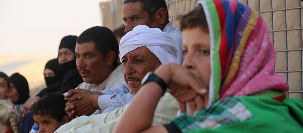 Iraqi families who fled Hawijah in northern Iraq, gather after arriving in the Kirkuk province, about 200 km north of the capital Baghdad, on August 7, 2016 Iraqi families who fled Hawijah in northern Iraq, gather after arriving in the Kirkuk province, about 200 km north of the capital Baghdad, on August 7, 2016 - Sputnik International