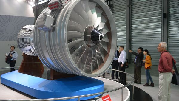 This file photo taken on November 7, 2013 shows visitors looking at a full-size model of an aircraft jet engine made by China Aviation Industry Corporation at the China International Industry Fair in Shanghai - Sputnik International
