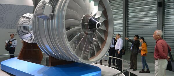 This file photo taken on November 7, 2013 shows visitors looking at a full-size model of an aircraft jet engine made by China Aviation Industry Corporation at the China International Industry Fair in Shanghai This file photo taken on November 7, 2013 shows visitors looking at a full-size model of an aircraft jet engine made by China Aviation Industry Corporation at the China International Industry Fair in Shanghai - Sputnik International