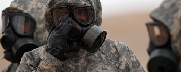 Soldiers wear mask sas they take part in a military exercise simulating a chemical weapons attack during the international Eager Lion military event on June 2, 2014 at Prince Hashem Bin Abdullah II training center, in Zarqa, 30 km east of Amman, Jordan - Sputnik International