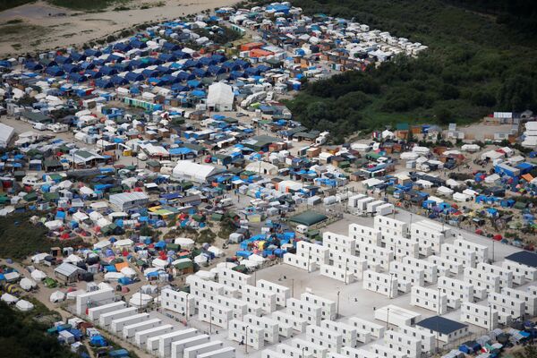 Aerial view of a makeshift camp as containers (front) are put into place to house migrants living in what is known as the Jungle, a sprawling camp in Calais, France, August 14, 2016 Aerial view of a makeshift camp as containers (front) are put into place to house migrants living in what is known as the Jungle, a sprawling camp in Calais, France, August 14, 2016 - Sputnik International