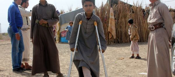 Mabruk Mughrabi (C), a Yemeni boy injured in his leg as a result of a land mine, stands with friends at a camp for internally displaced on the outskirts of Marib on April 15, 2016 Mabruk Mughrabi (C), a Yemeni boy injured in his leg as a result of a land mine, stands with friends at a camp for internally displaced on the outskirts of Marib on April 15, 2016 - Sputnik International