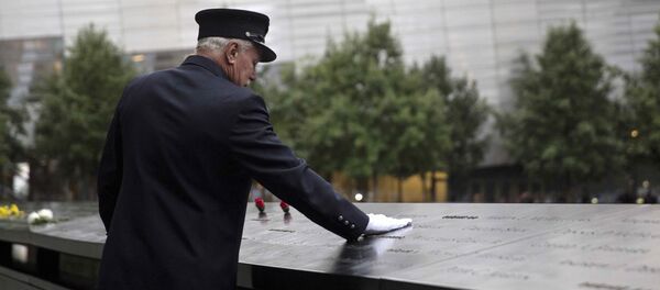 A member of the New York Fire Department places his hand on the memorial before a ceremony marking the 14th anniversary of the 9/11 attacks, at the National September 11 Memorial and Museum in Lower Manhattan in New York A member of the New York Fire Department places his hand on the memorial before a ceremony marking the 14th anniversary of the 9/11 attacks, at the National September 11 Memorial and Museum in Lower Manhattan in New York - Sputnik International