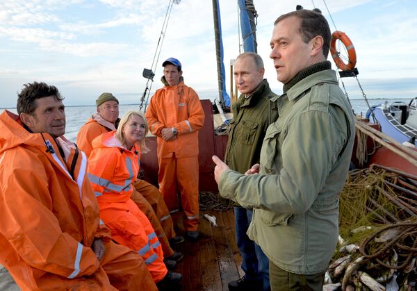September 10, 2016. Russian President Vladimir Putin, second right, and Prime Minister Dmitry Medvedev, right, talk with fishermen during a boat tour of Lake Ilmen, Novgorod Region. September 10, 2016. Russian President Vladimir Putin, second right, and Prime Minister Dmitry Medvedev, right, talk with fishermen during a boat tour of Lake Ilmen, Novgorod Region. - Sputnik International