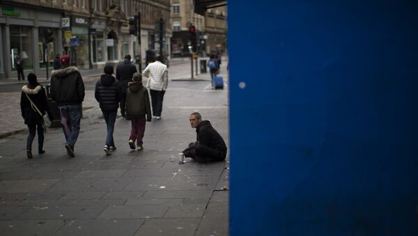 In this Sunday, July 3, 2016 photo, people walk by a beggar at a street in downtown Glasgow, Scotland - Sputnik International