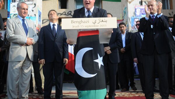 Britain's Prime Minister David Cameron addresses the gathering from a podium decked with the National Transitional Council's (NTC) adopted flag in Benghazi on September 15, 2011. - Sputnik International